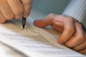 Man's Hands Signing Document