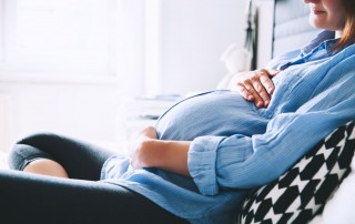 pregnant woman holding stomach