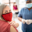 women wearing mask with bandage on arm after vaccine