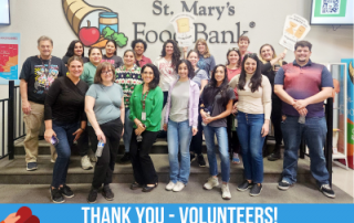 Group of ADHS employees posing for a photo at St. Mary's Food Bank, after a day of packing emergency food boxes.