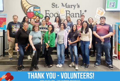 Group of ADHS employees posing for a photo at St. Mary's Food Bank, after a day of packing emergency food boxes.