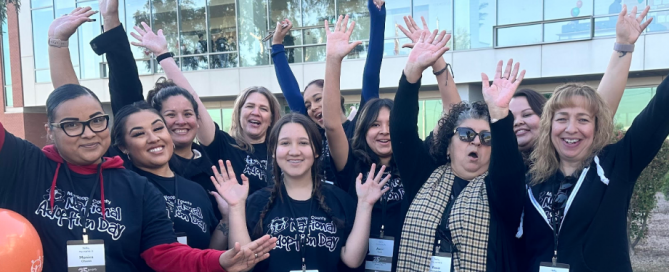 photo of vital records team members with smiles and cheers as they stand outside of their annual adoption day event