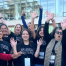 photo of vital records team members with smiles and cheers as they stand outside of their annual adoption day event