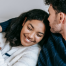 a young couple (woman and man) embracing and smiling together